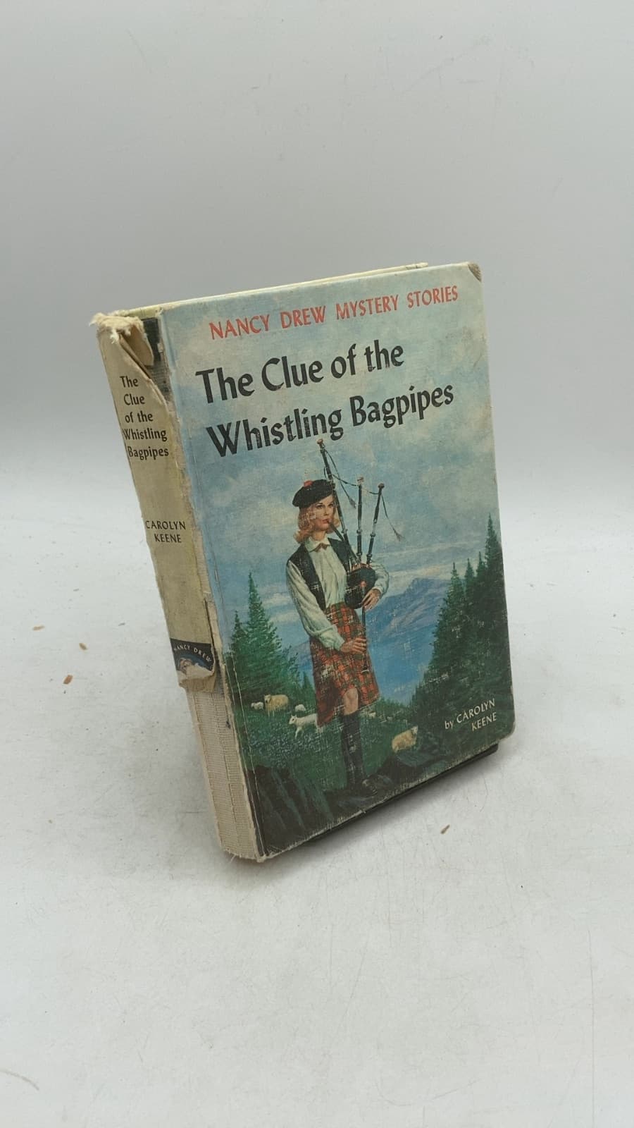 The Clue of the Whistling Bagpipes by Carolyn Keene - front cover